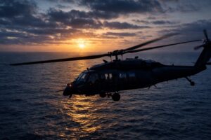 Search and rescue boats using bright spotlights on the dark ocean at dusk following a military helicopter crash.