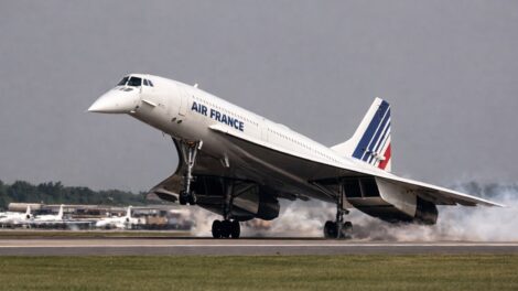 An image of a supersonic passenger aircraft, Concorde, on final landing approach with its unique nose fully drooped by 12.5 degrees and a high angle of attack.
