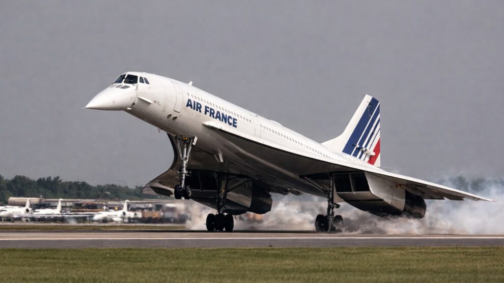 An image of a supersonic passenger aircraft, Concorde, on final landing approach with its unique nose fully drooped by 12.5 degrees and a high angle of attack.