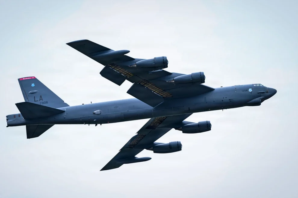US Air Force B-52 Stratofortress heavy bomber with LA tail code soaring through a cloudy sky.