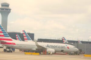 Airport apron showing aircraft parking stands, ground support equipment, fueling, loading, and service roads