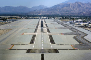 Runway at an airport showing takeoff and landing surface, markings, lights, taxiways, and apron connection