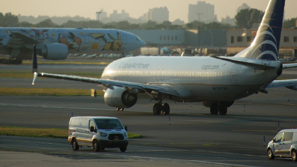 Taxiway at an airport showing aircraft ground movement between runway, apron, terminal, and marked taxi routes